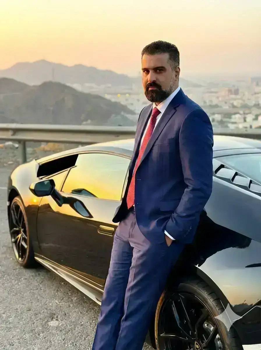 handsome South Asian man in his late 20s to early 30s, sharp jawline, thick well-groomed mustache, confident intense gaze directly at camera
